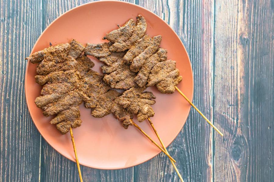 A plae with suya meat skewers.