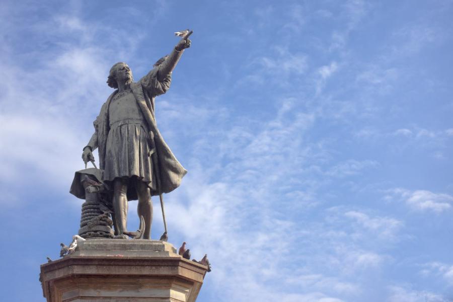 A statue of Christopher Columbus pointing to the New World.