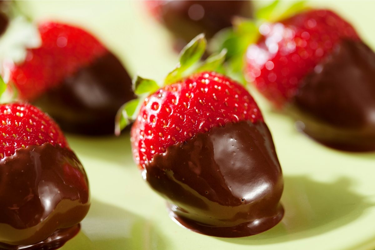 A few strawberries half coated with chocolate.