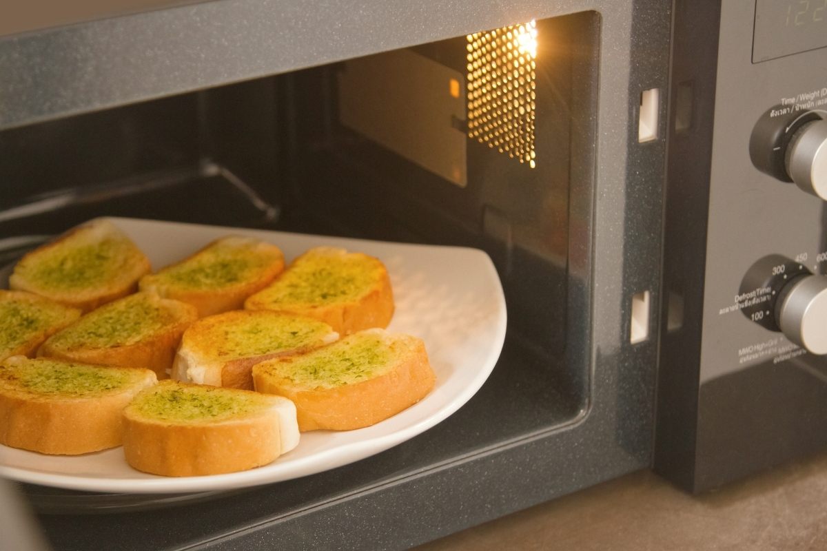 Home cooked garlic bread in microwave oven.