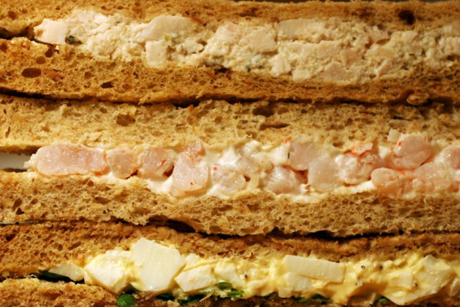 Detail of chicken salad sandwich, shrimp mayo sandwich and egg salad sandwich.