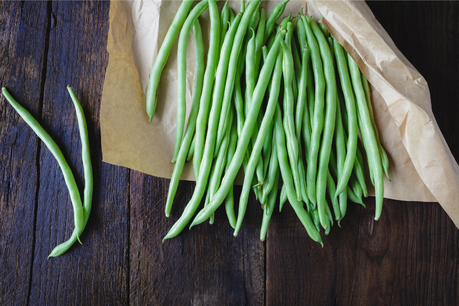 Fresh green beans in a paper bag.