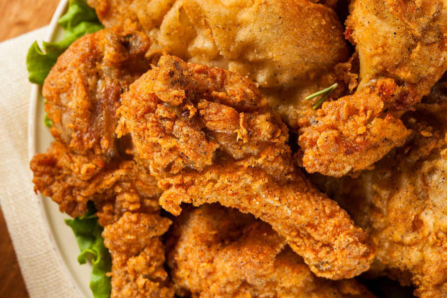 A plate with pieces of Southern fried chicken.