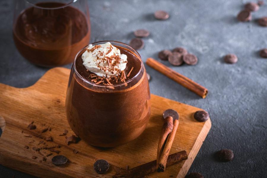 Dark chocolate mousse decorated with whipped cream.
