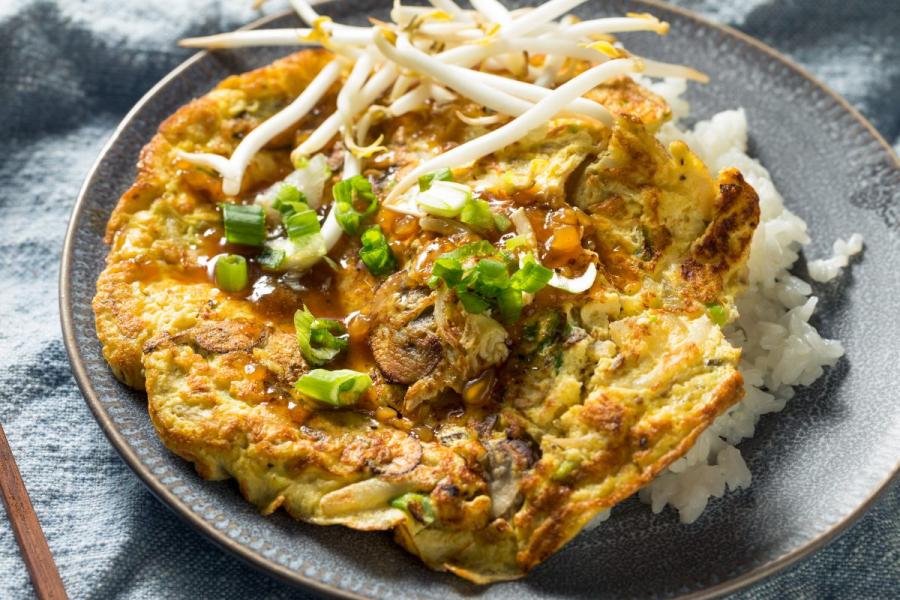 Homemade egg foo young with green onion and bean sprouts.
